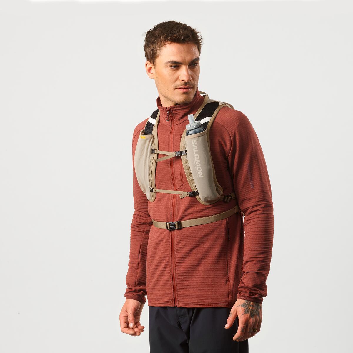 Salomon Cross 8 Trailrunning-Rucksack in Beige an einem Mann, Vorderansicht